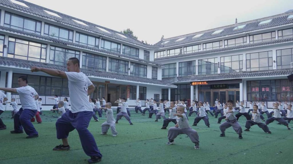 image shows shaolin kung fu teacher and students